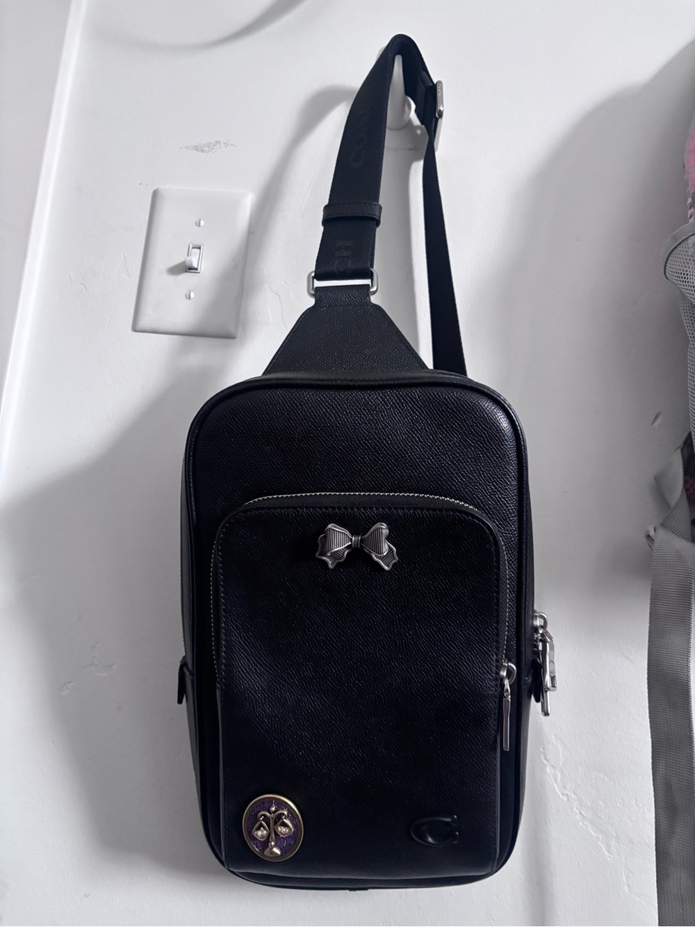 Coach Black Leather Crossbody Sling Bag with Bow Accent from the Coach store